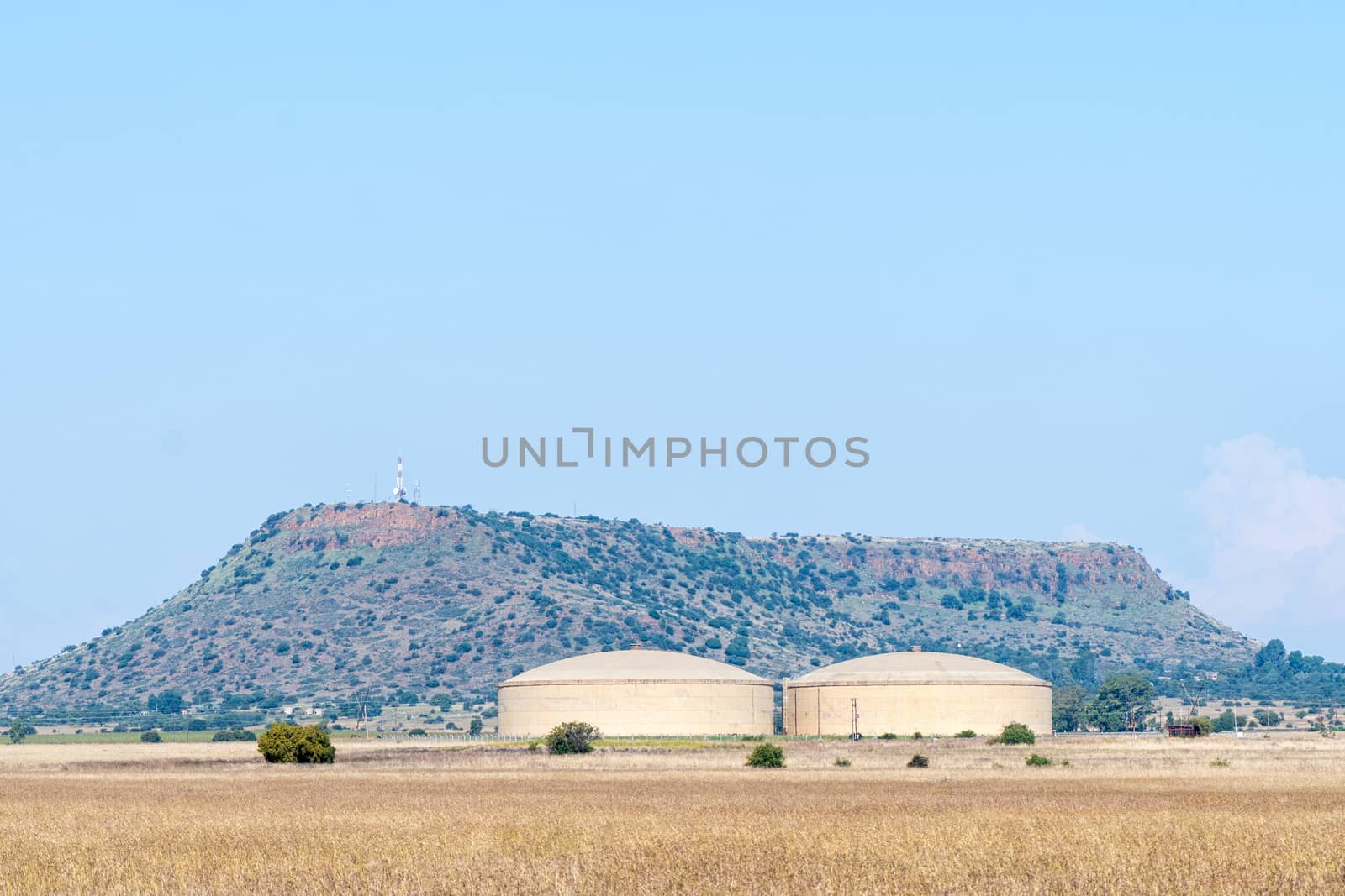 Water reservoirs at the Beatrix mine near Welkom in the Free State Province. Telecommunications infrastructure are visible on a hill