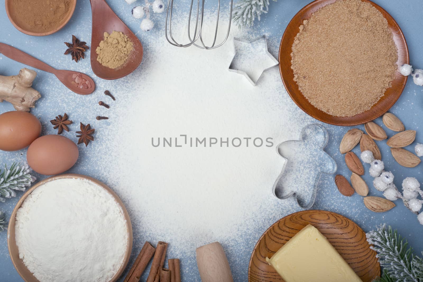 Christmas gingerbread cookies cooking background flat lay top view template with copy space for text. Baking utensils, spices and food ingredients on blue background