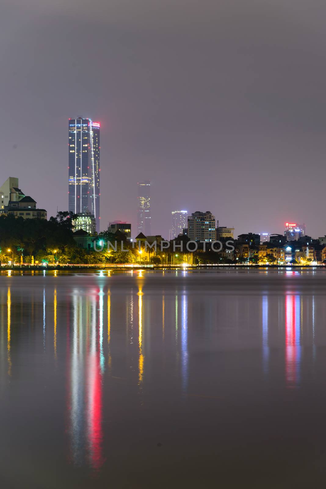 Colorful skyline reflection of downtown Hanoi skyscrapers from West Lake by trongnguyen