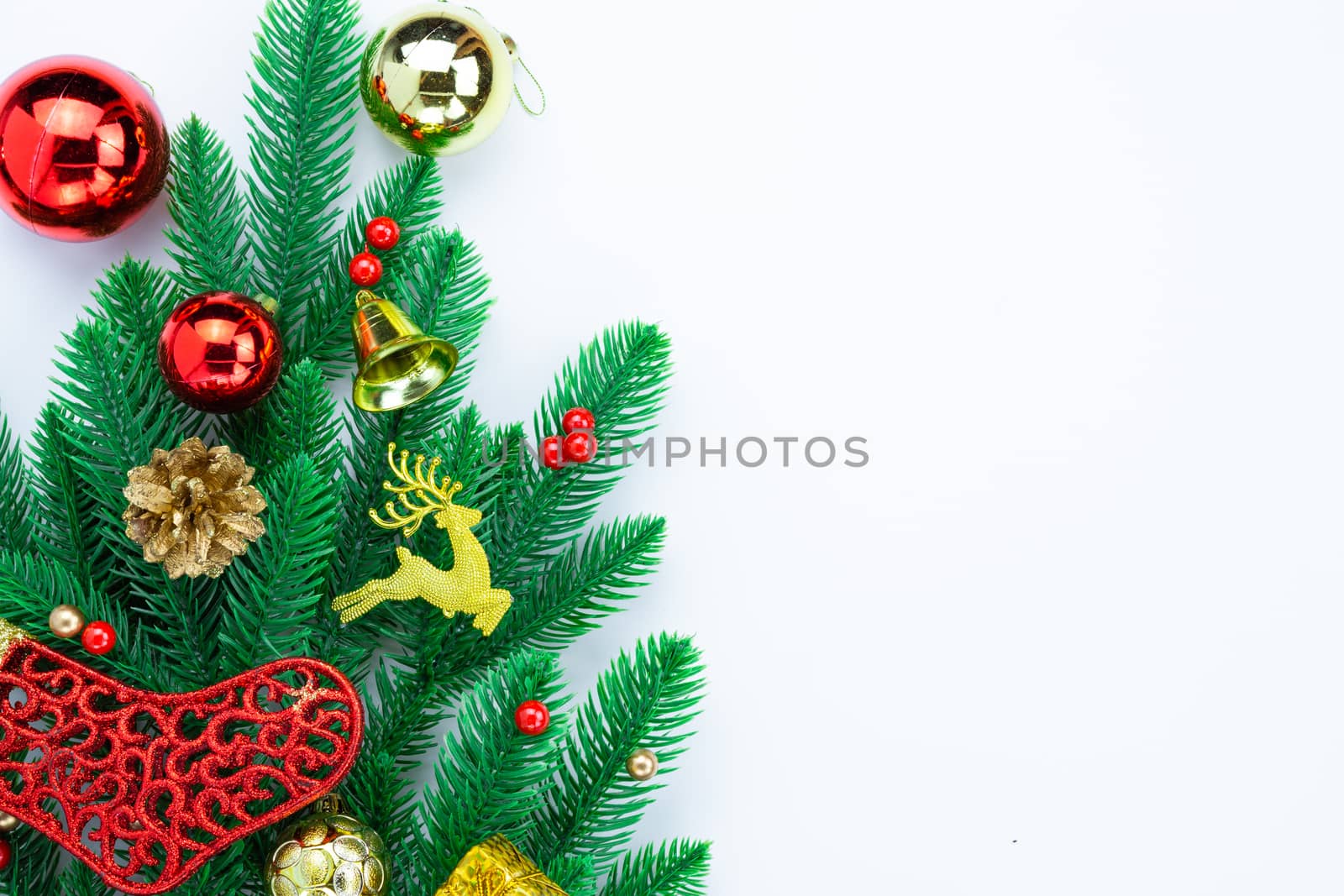 Christmas holidays composition, top view of red and gold Christmas decorations on white background with copy space for text. Flat lay, winter, postcard template, new year concept.