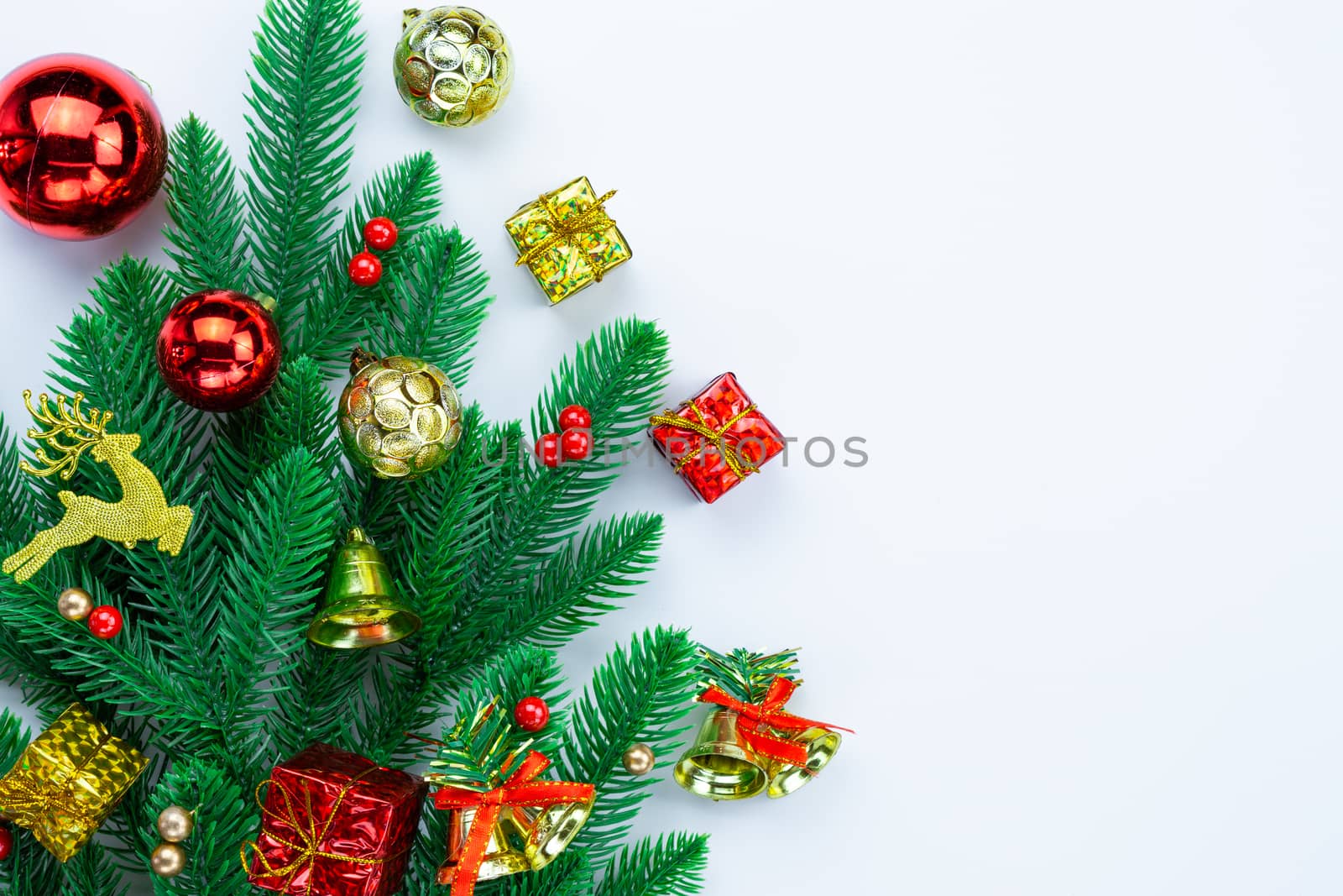 Christmas holidays composition, top view of red and gold Christmas decorations on white background with copy space for text. Flat lay, winter, postcard template, new year concept.