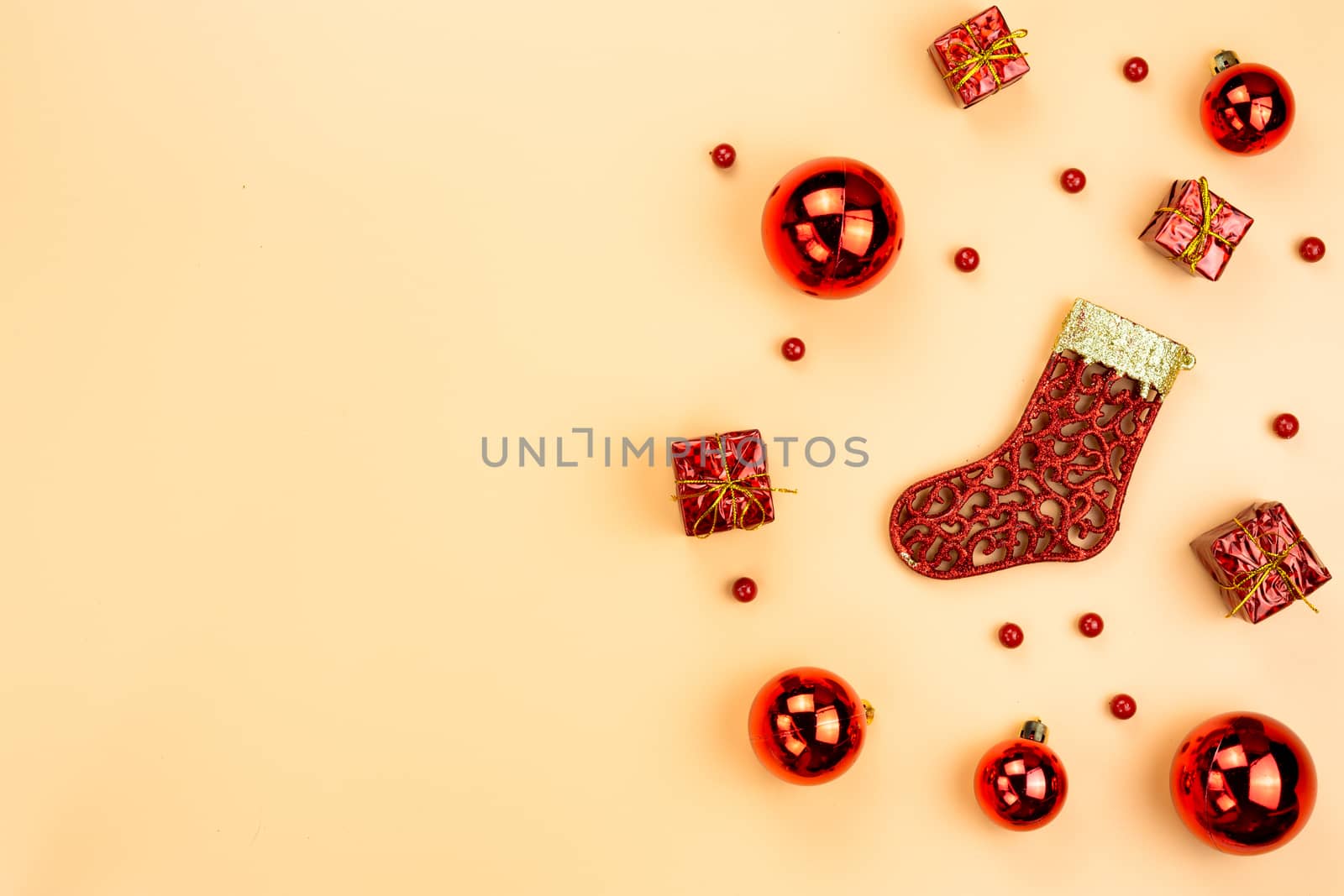 Christmas holidays composition, top view of red Christmas decorations on yellow background with copy space for text. Flat lay, winter, postcard template, new year concept.