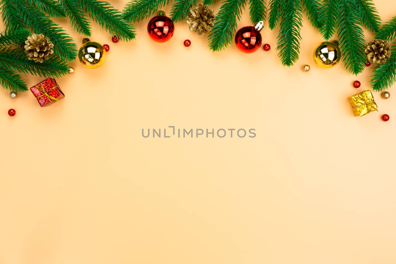 Christmas holidays composition, top view of red and gold Christmas decorations on yellow background with copy space for text. Flat lay, winter, postcard template, new year concept.