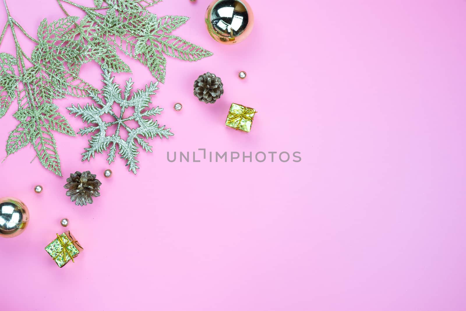 Christmas holidays composition, top view of gold Christmas decorations on pink background with copy space for text. Flat lay, winter, postcard template, new year concept.