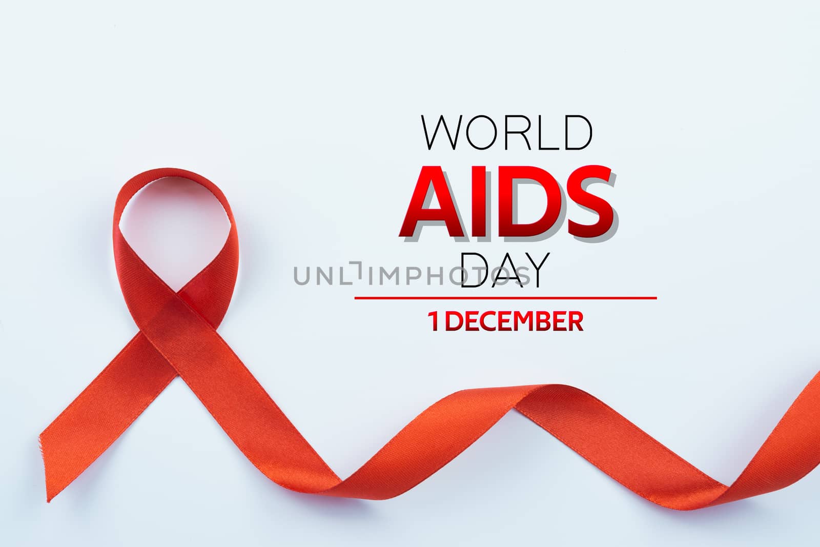 Aids awareness, red ribbon on white background with copy space for text. World Aids Day, Healthcare and medical concept.