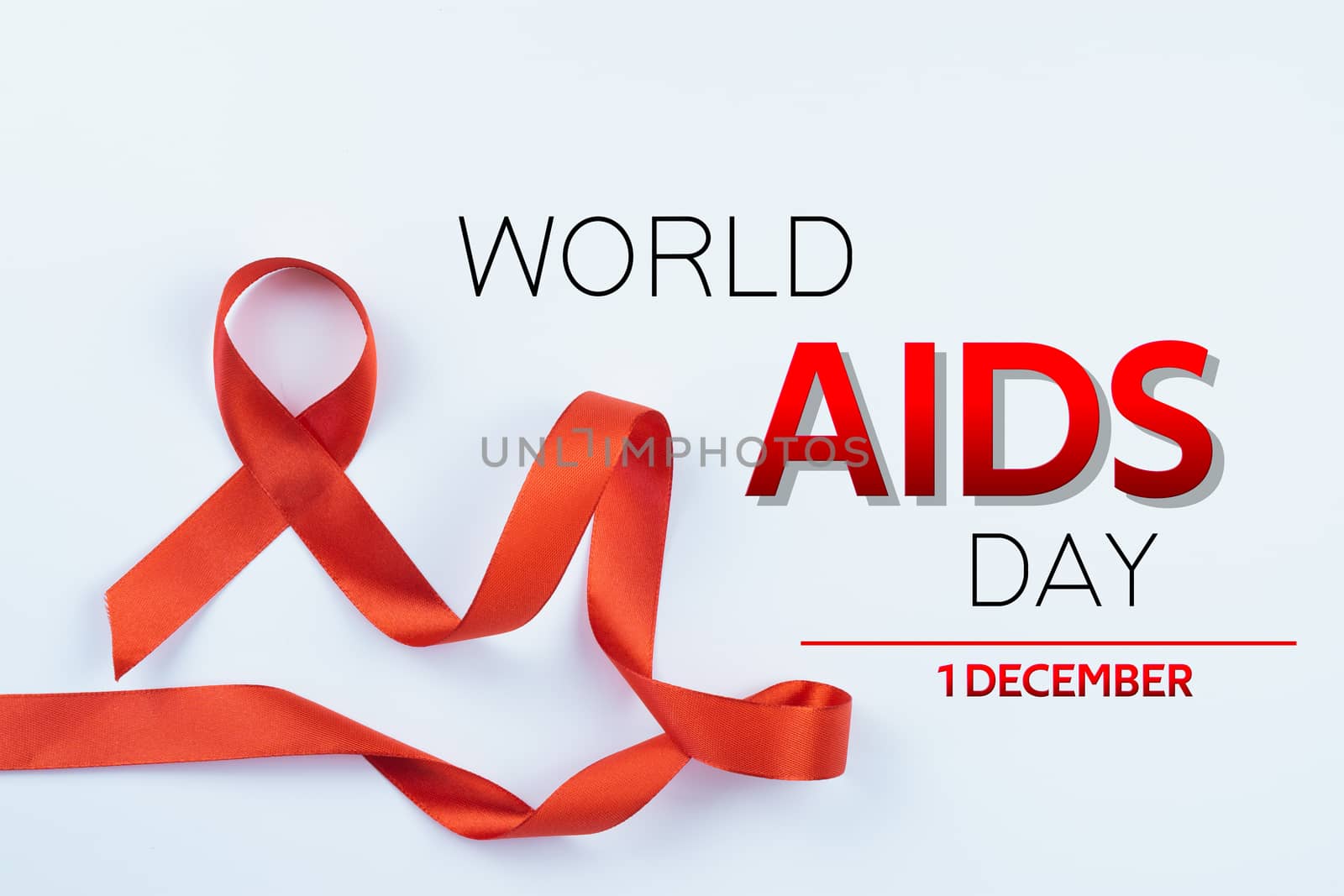 Aids awareness, red ribbon on white background with copy space for text. World Aids Day, Healthcare and medical concept.