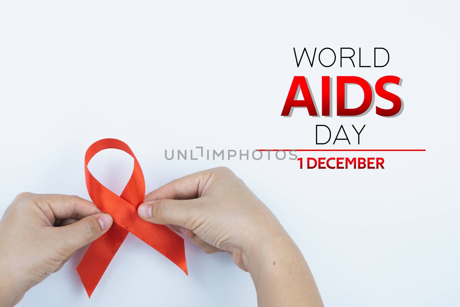 Aids awareness, male hands holding red AIDS awareness ribbon on white background. World Aids Day, Healthcare and medical concept.