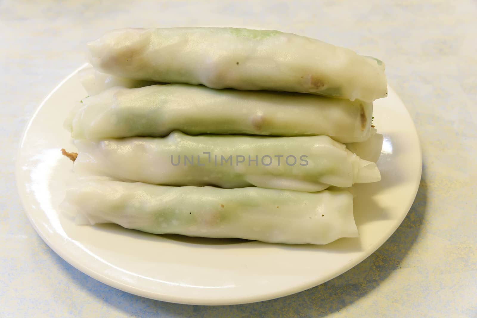 Top view a dish of fresh noodle rolls (Pho Cuon) containing beef and herbs. It is slightly sweet and spicy but light and fresh. A Vietnamese cuisineof Hanoi, loved by both tourist and local.