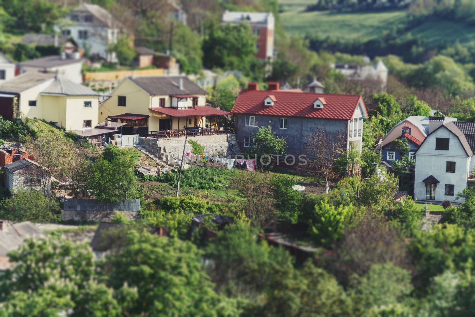 Landscape summer sunny view of a small village in the valley. Kamenets Podolsky. Ukraine. Effect tilt-shifted perspectives.