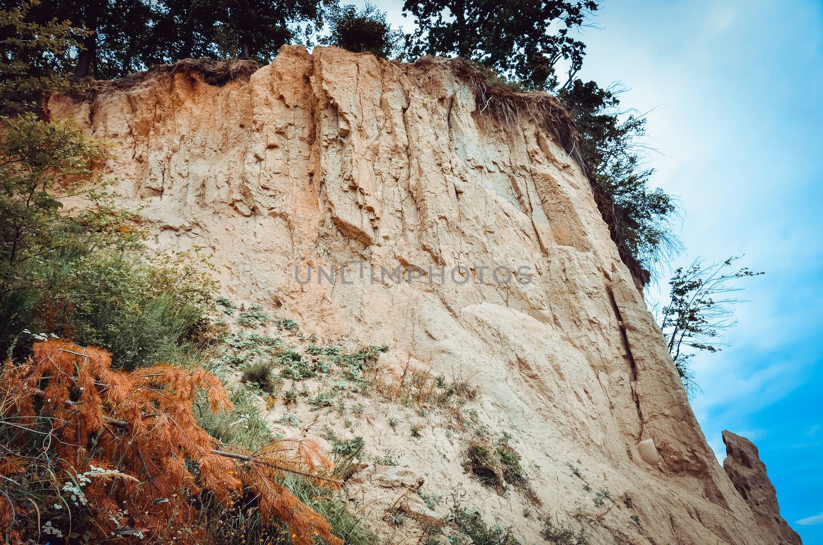 Clear strata within the cliff under blue sky