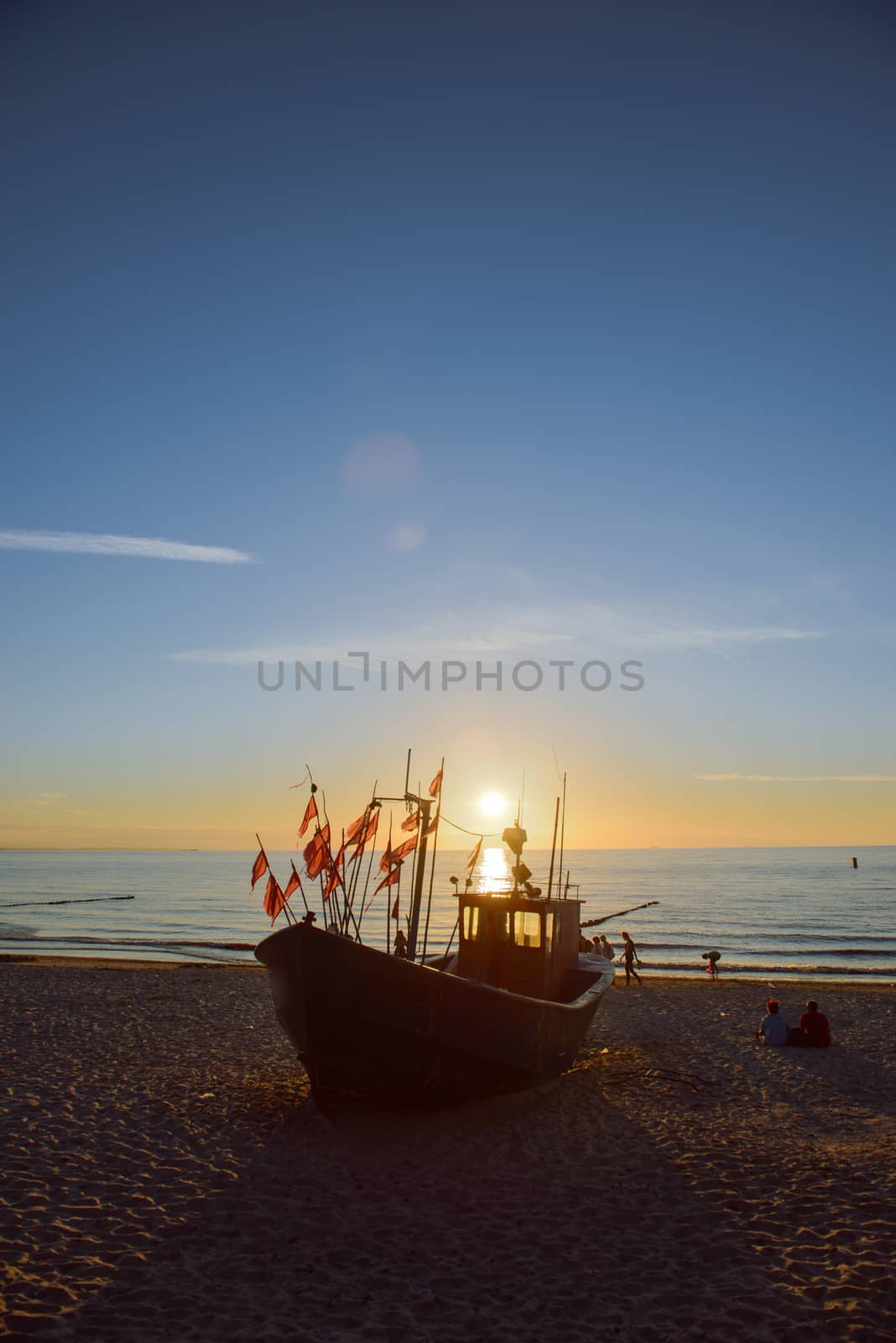 fisherman boats at sunrise time on the beach in summer