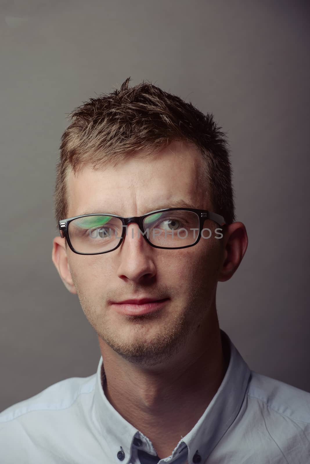 Portrait of a smart serious young man.
