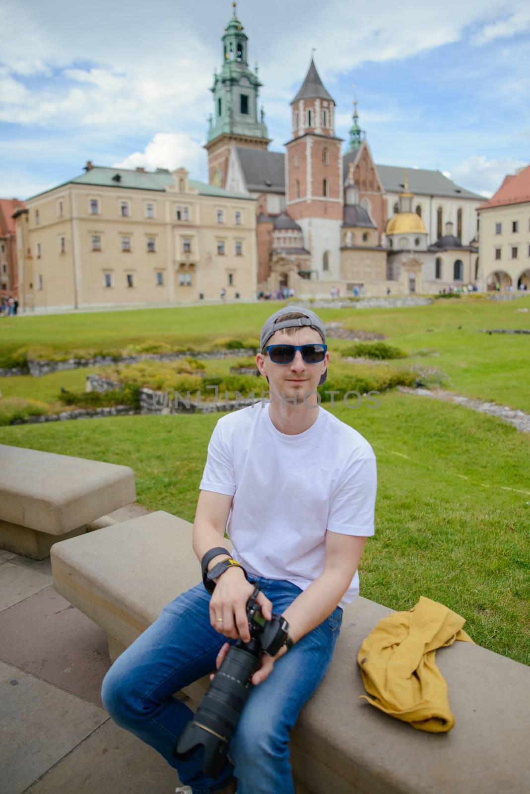 Man during sightseeing old castle in Cracow, Wawel. by Brejeq
