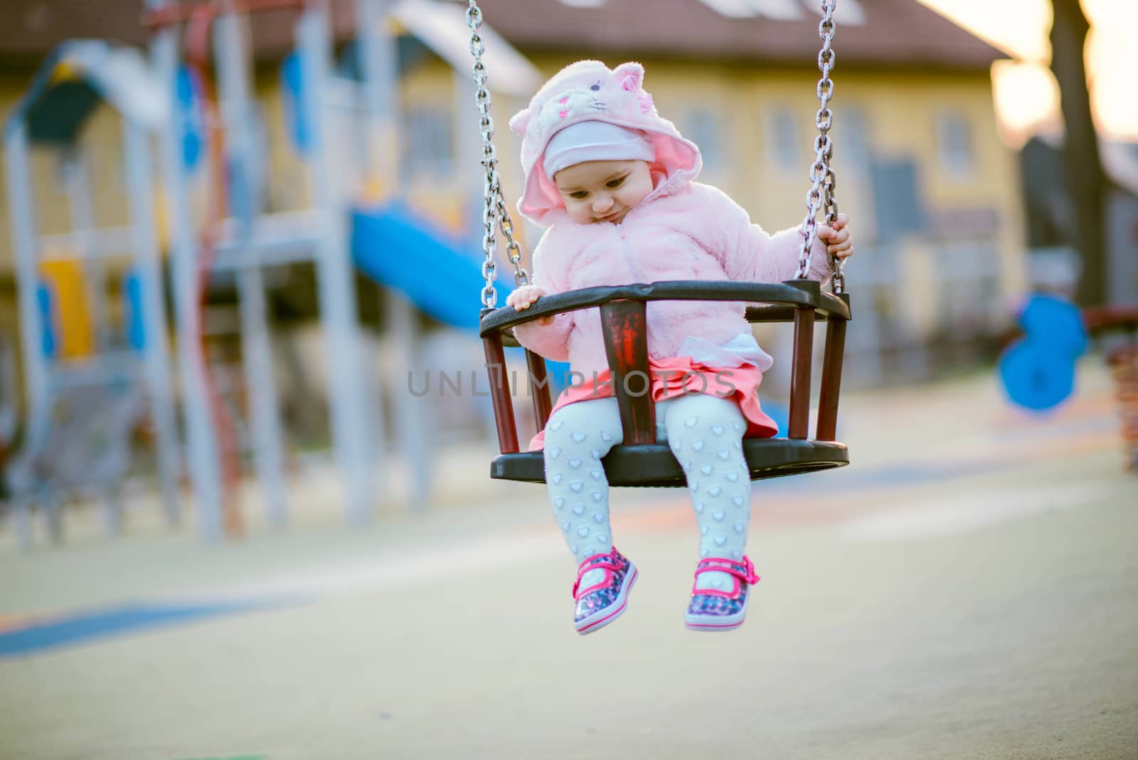 Little girl spending fantastic time on playground. Happy childhood. Authentic image