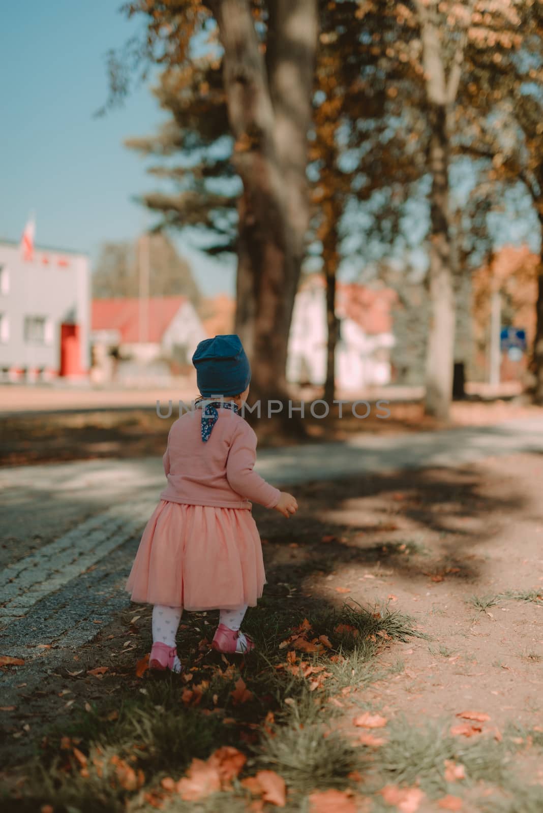 Adorable girl having fun on beautiful autumn day. authentic childhood image