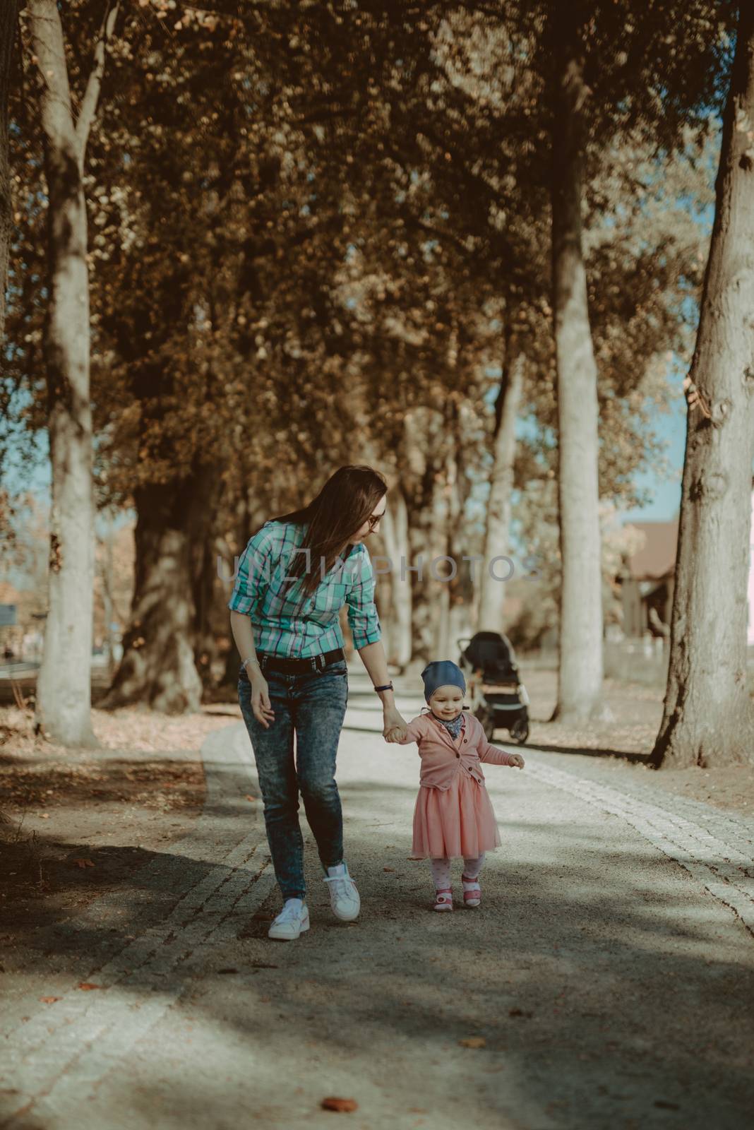 Happy loving family. Father and his daughter child girl playing and hugging outdoors. Cute little girl hugs daddy. Concept of Father's day. Authentic image.