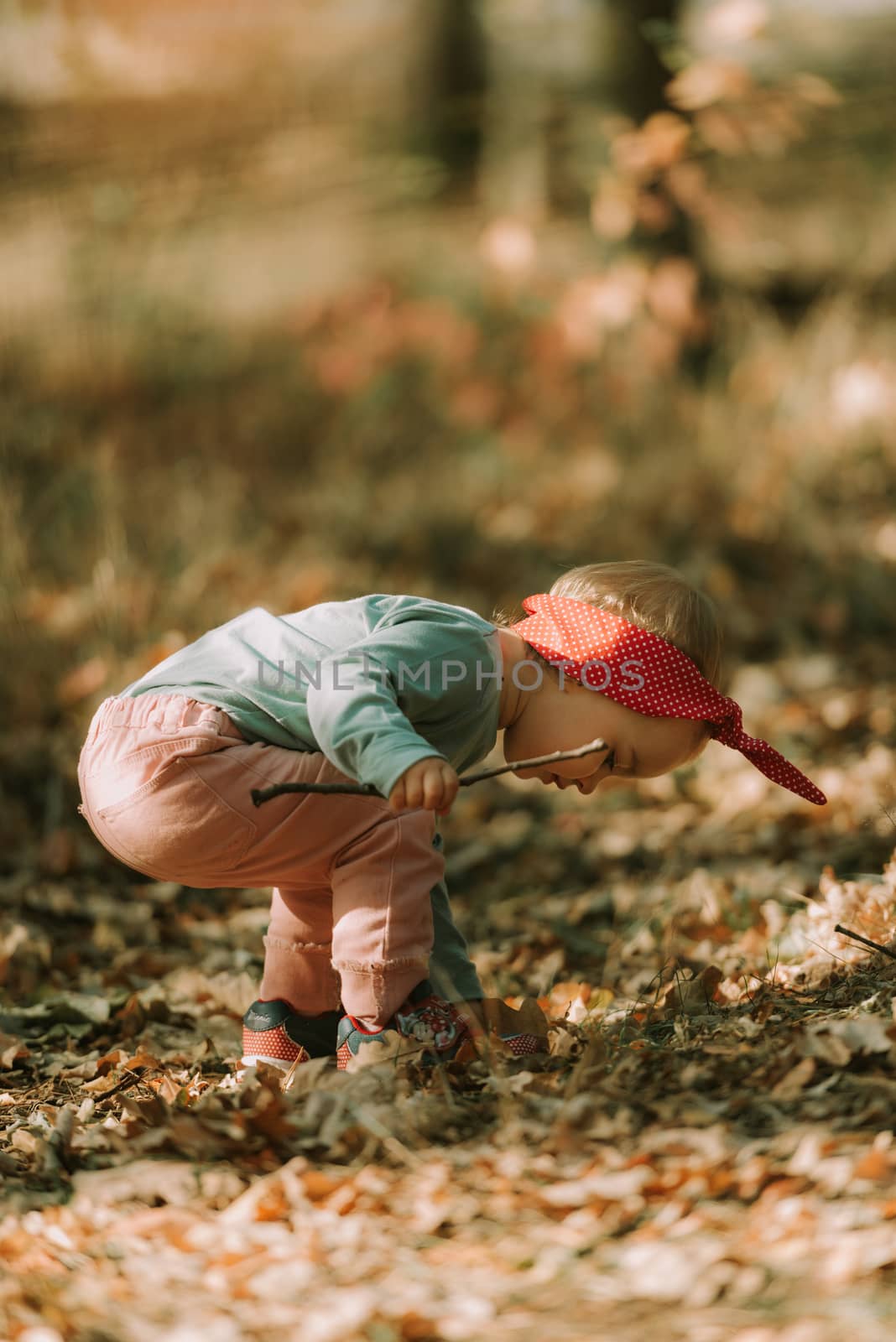 Adorable girl having fun on beautiful autumn day. authentic childhood image