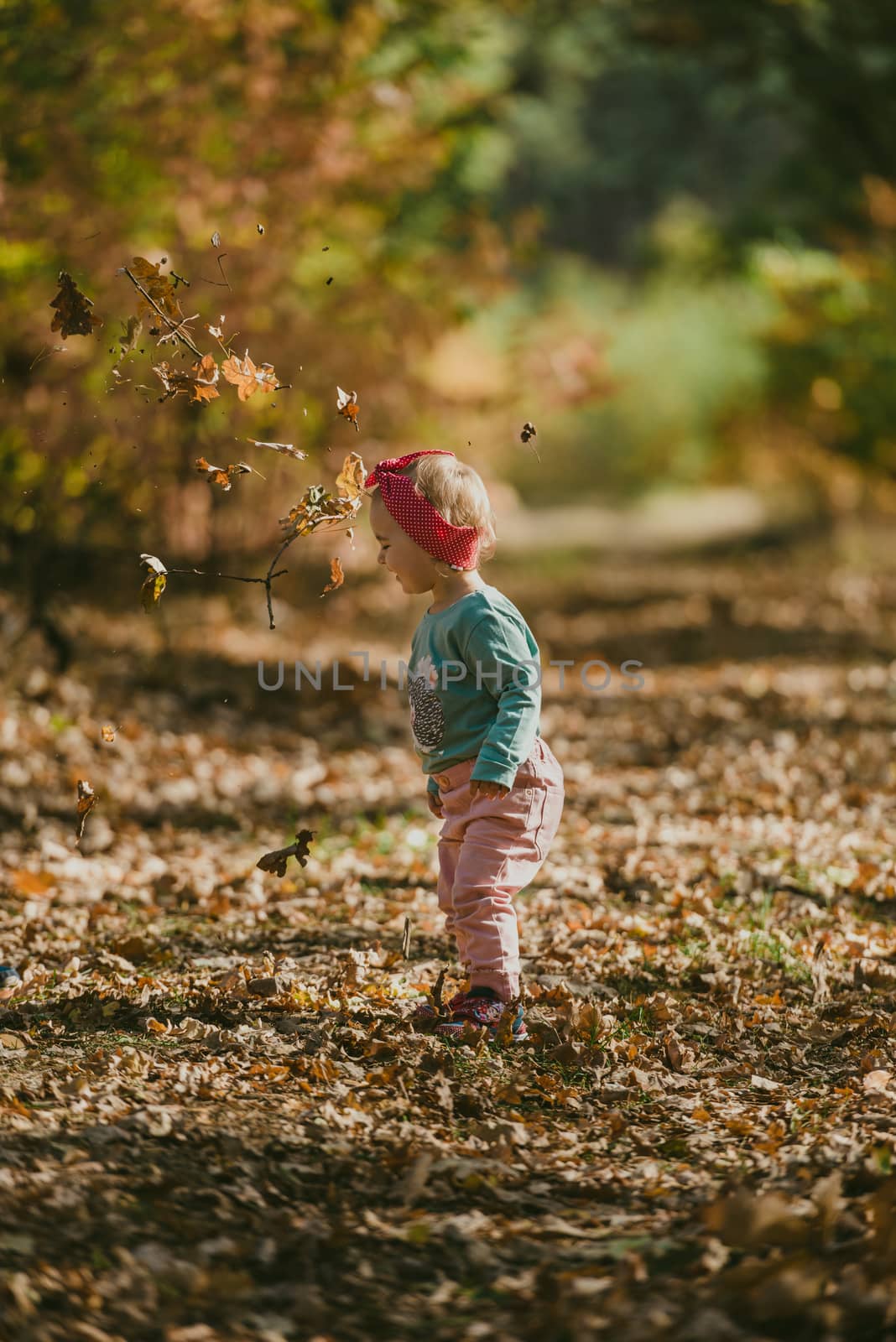 Adorable girl having fun on beautiful autumn day. authentic childhood image
