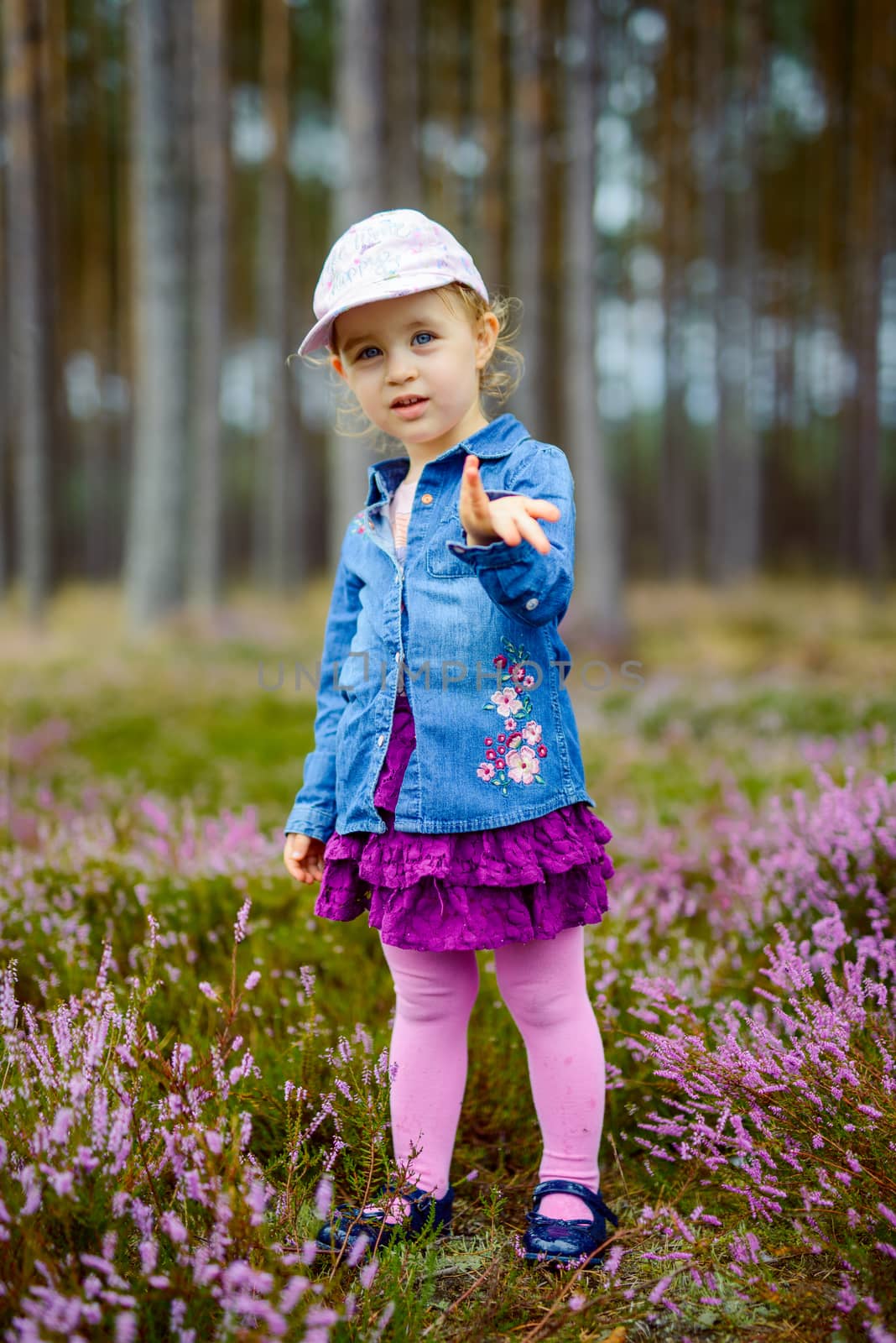 Adorable girl having fun on beautiful autumn day. authentic childhood image