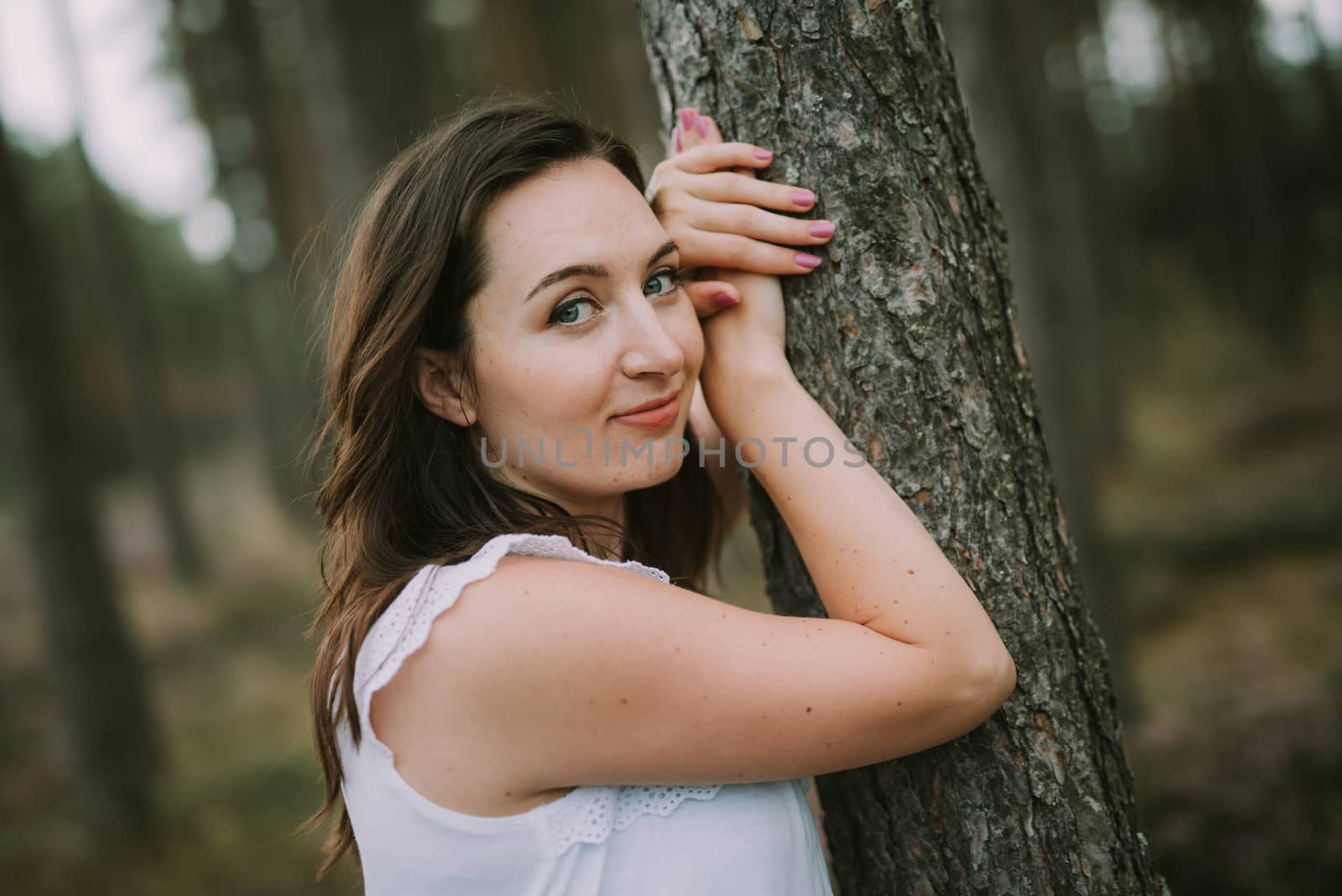 a photo of woman in the forest where the purple heather blooms. copy space. authentic image. by Brejeq