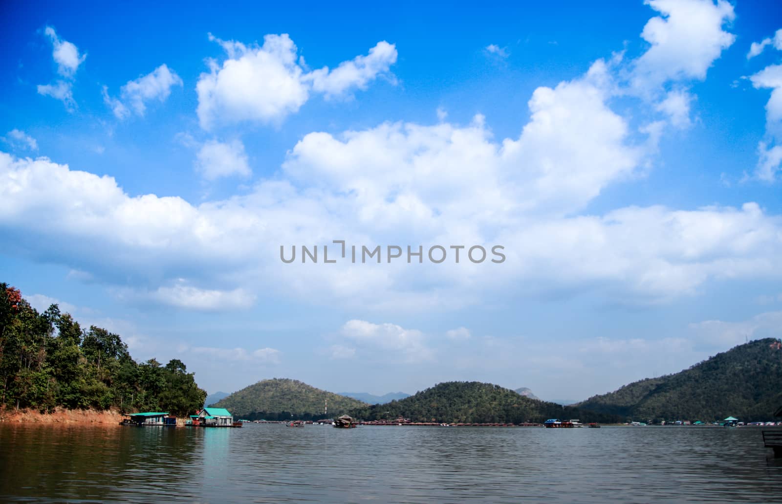 A beautiful scenery With a river in front of the mountain There were sky and clouds on the mountains and trees on the mountains. by anlomaja
