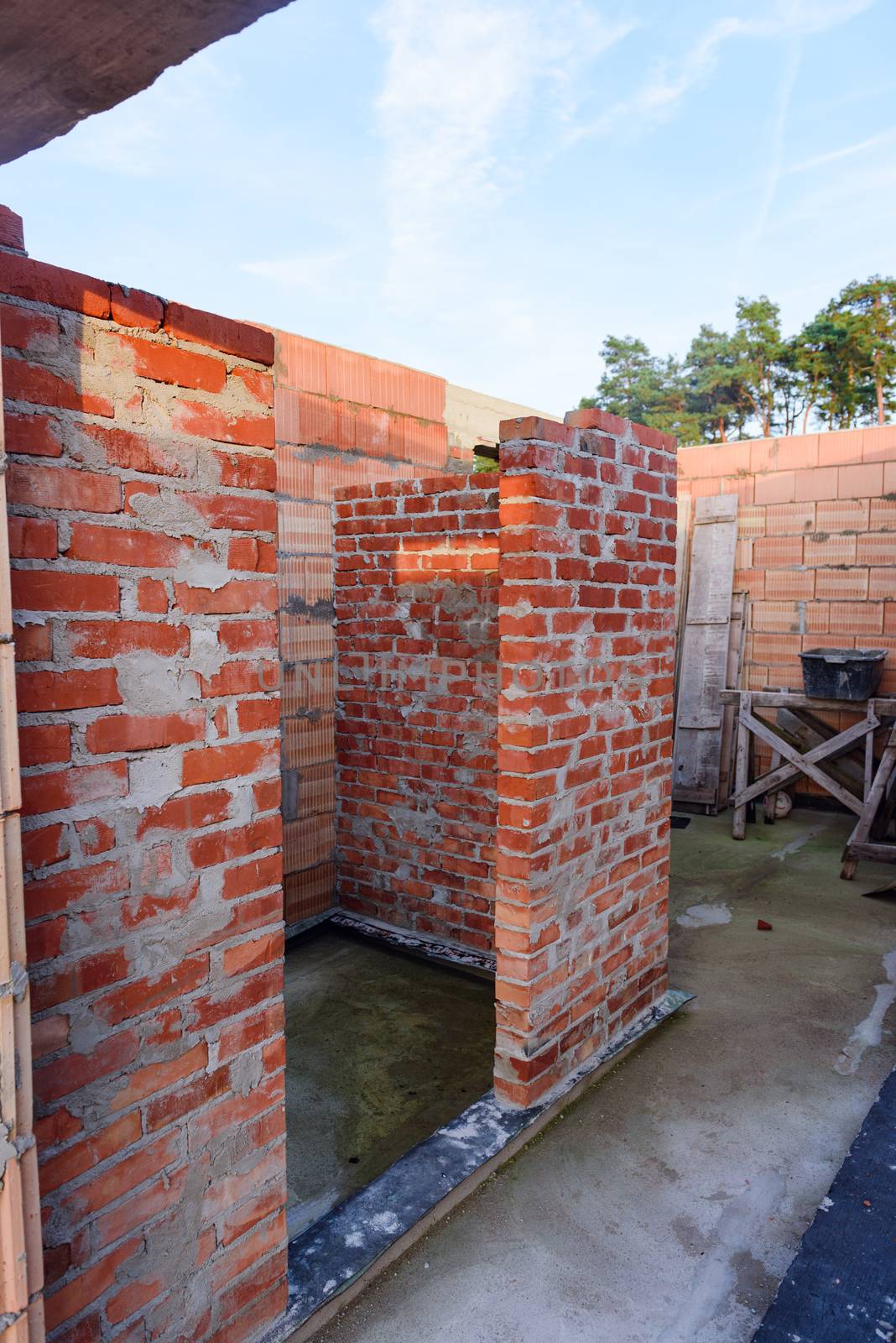 Interior of a Unfinished Red Brick House Walls under Construction without Roofing.