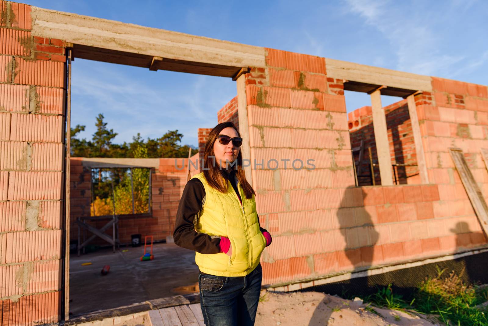 Exterior of a Unfinished Red Brick House Walls under Construction without Roofing.