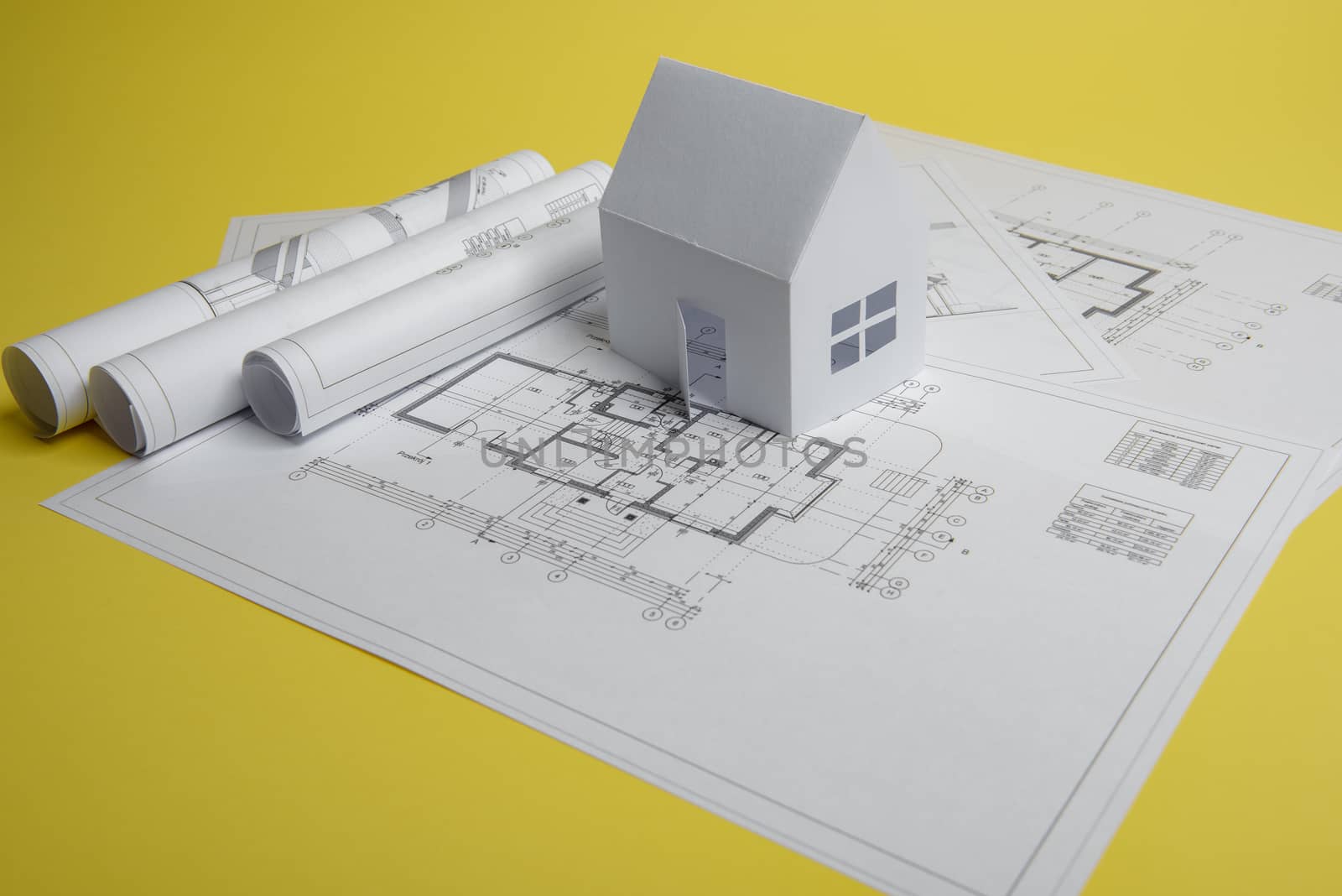Yellow paper block of flats on yellow background paper. Minimalistic and simple concept, style. Copy space. Horizontal orientation.