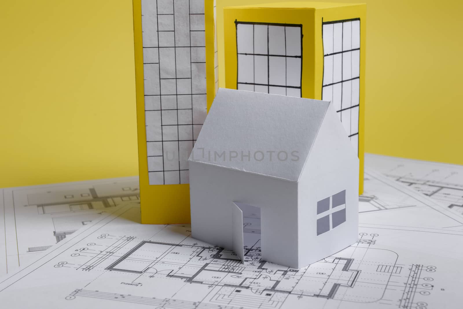 Yellow paper block of flats on yellow background paper. Minimalistic and simple concept, style. Copy space. Horizontal orientation.