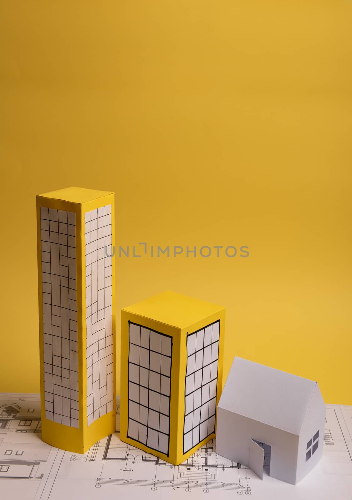 Yellow paper block of flats on yellow background paper. Minimalistic and simple concept, style. Copy space. Horizontal orientation.