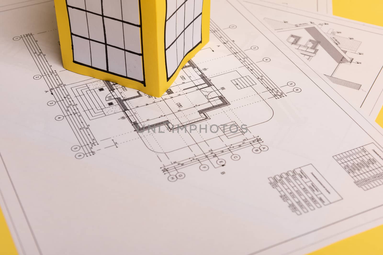 Yellow paper block of flats on yellow background paper. Minimalistic and simple concept, style. Copy space. Horizontal orientation.