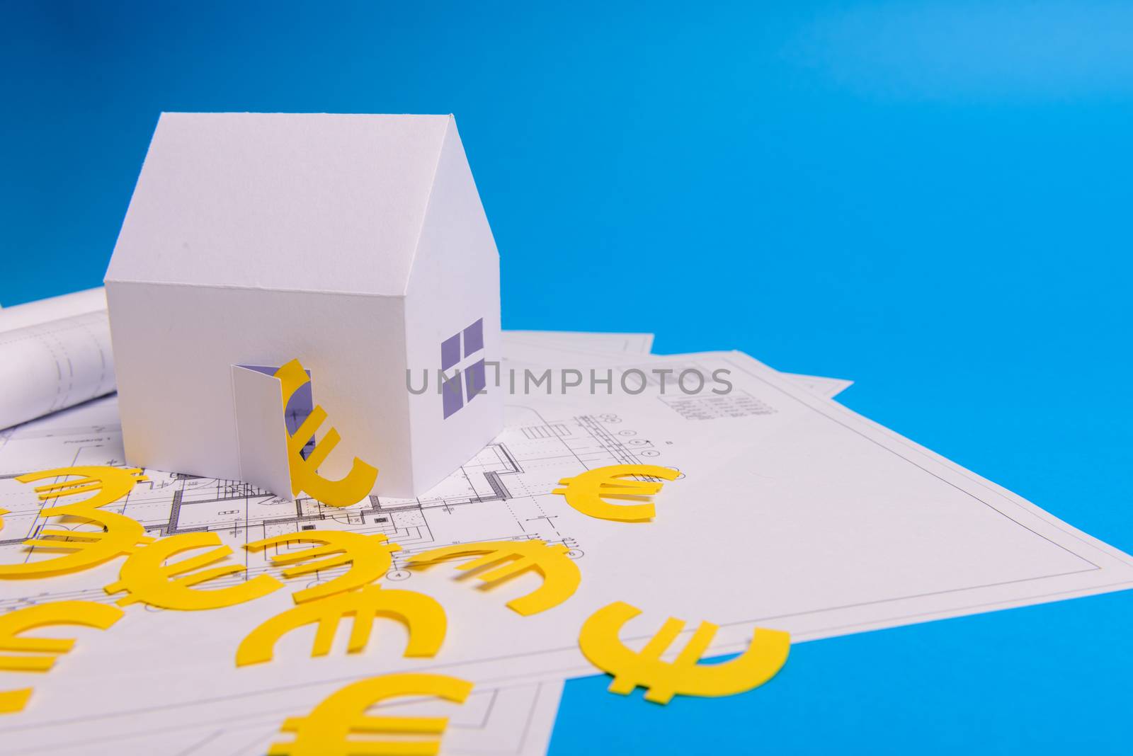 Paper skyscrapers , euro money, house projects plan and blueprints on blue background paper. Minimalistic and simple concept, style. Horizontal orientation. View from above.
