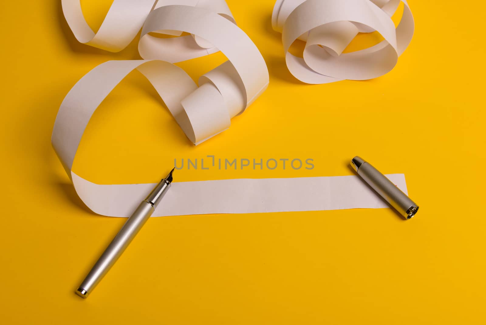 Long twisted expanded letter for Santa Claus. Copy space. yellow background