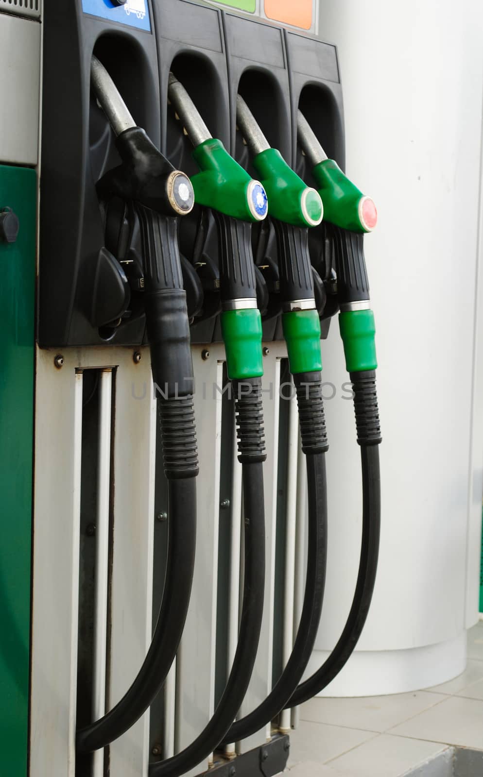 Gas station with three green handles and a black