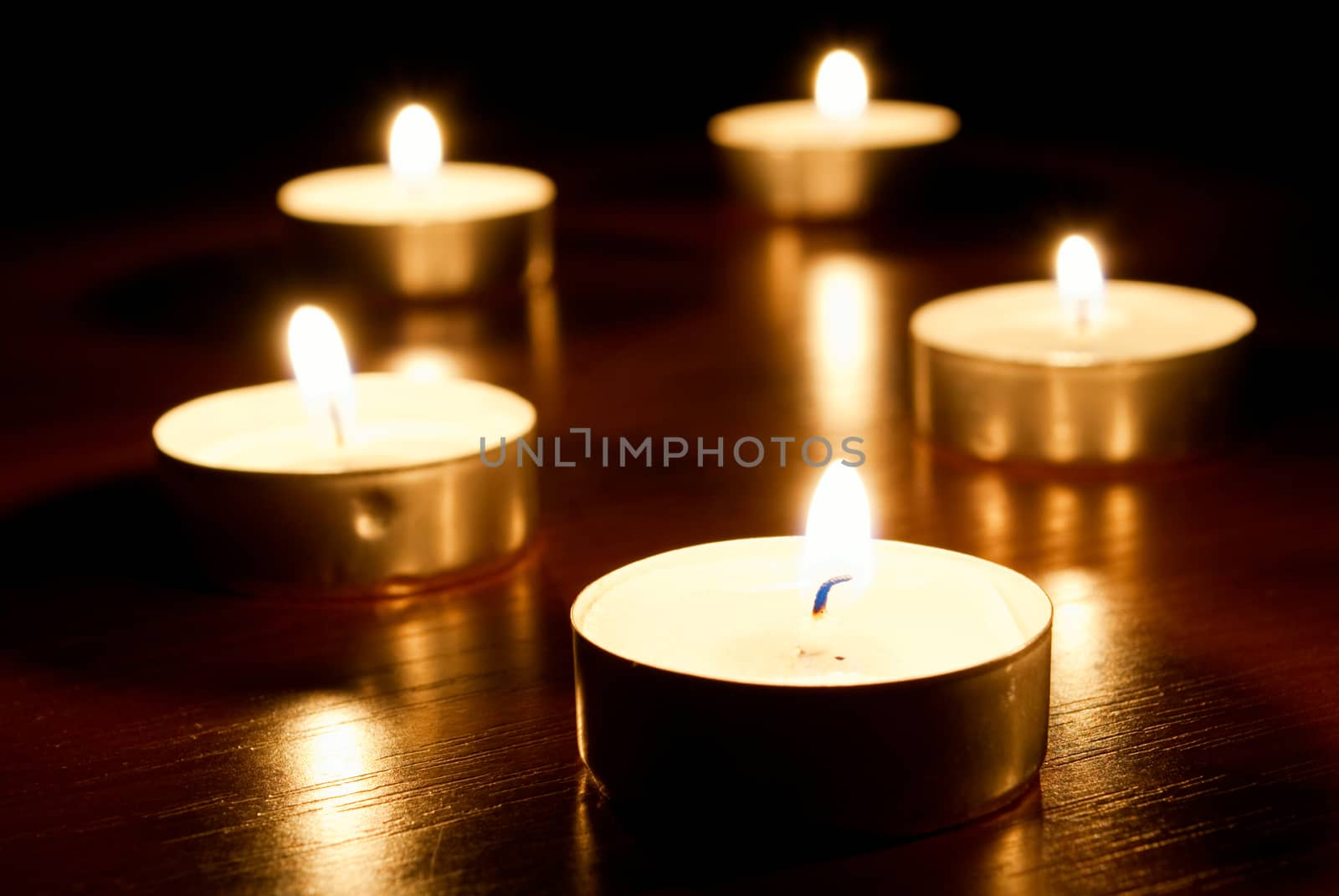 a row of votives with short depth of field.