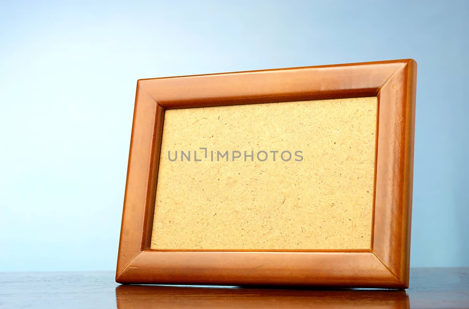 wooden photo frame on a blue background