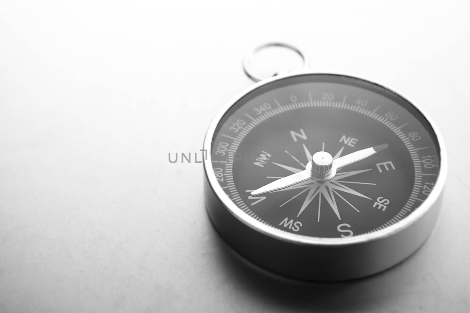 Compass on a gray gradient background, place for text