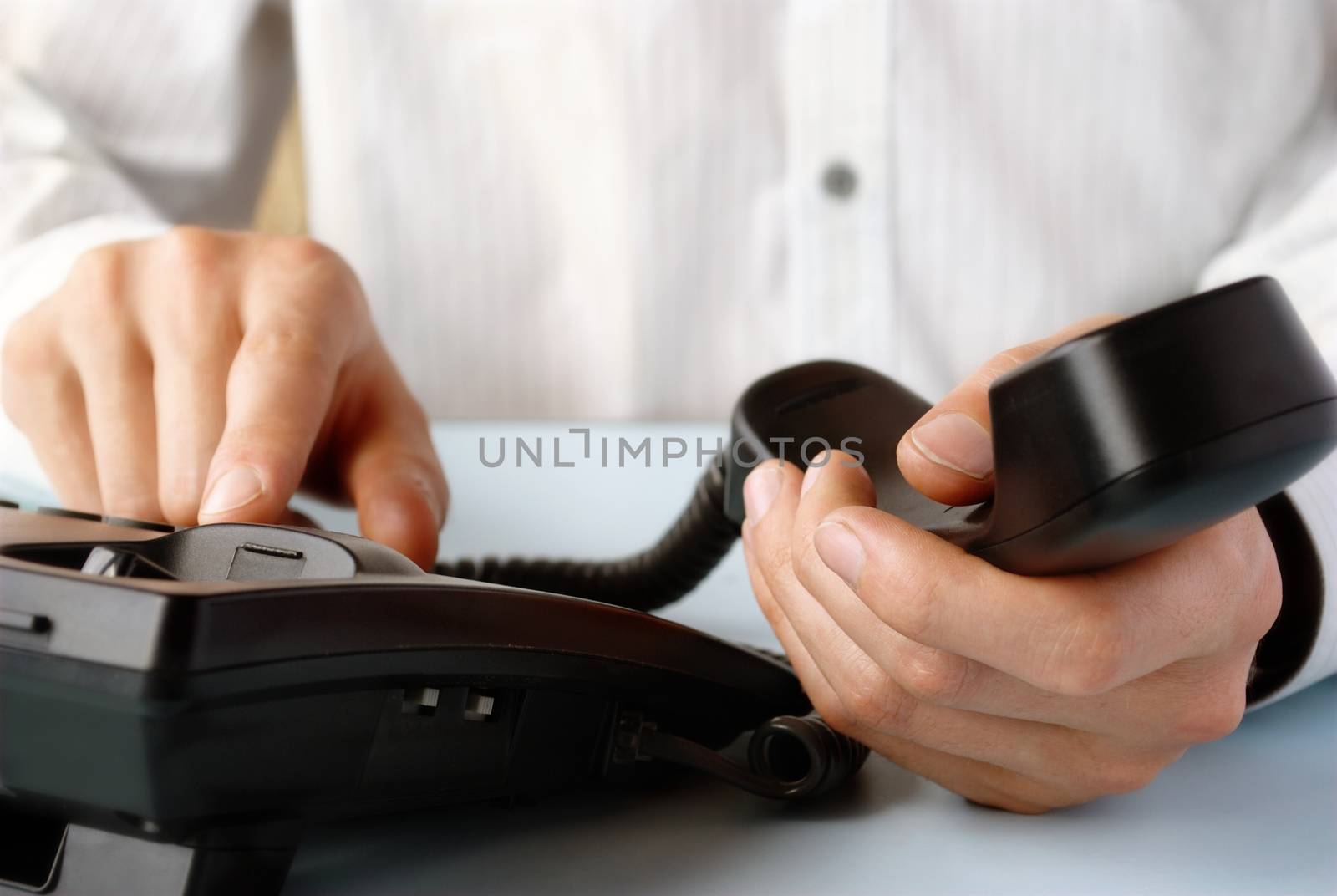 in the office of a man holding up the phone