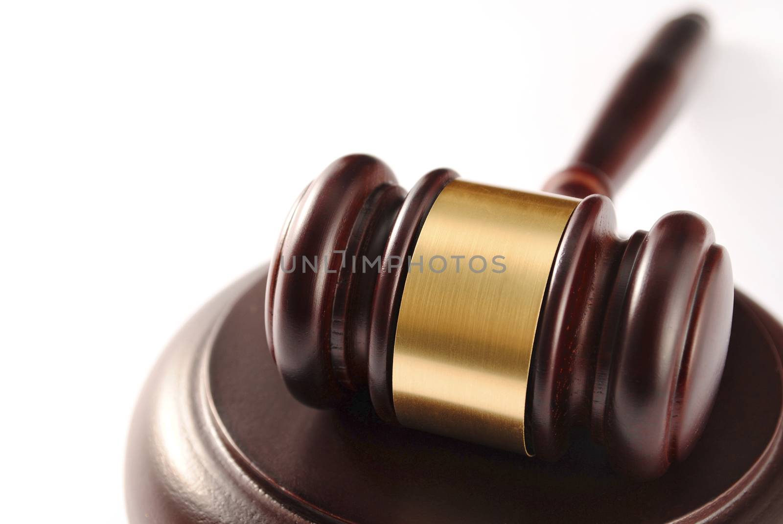 brown gavel with a brass band on a white background