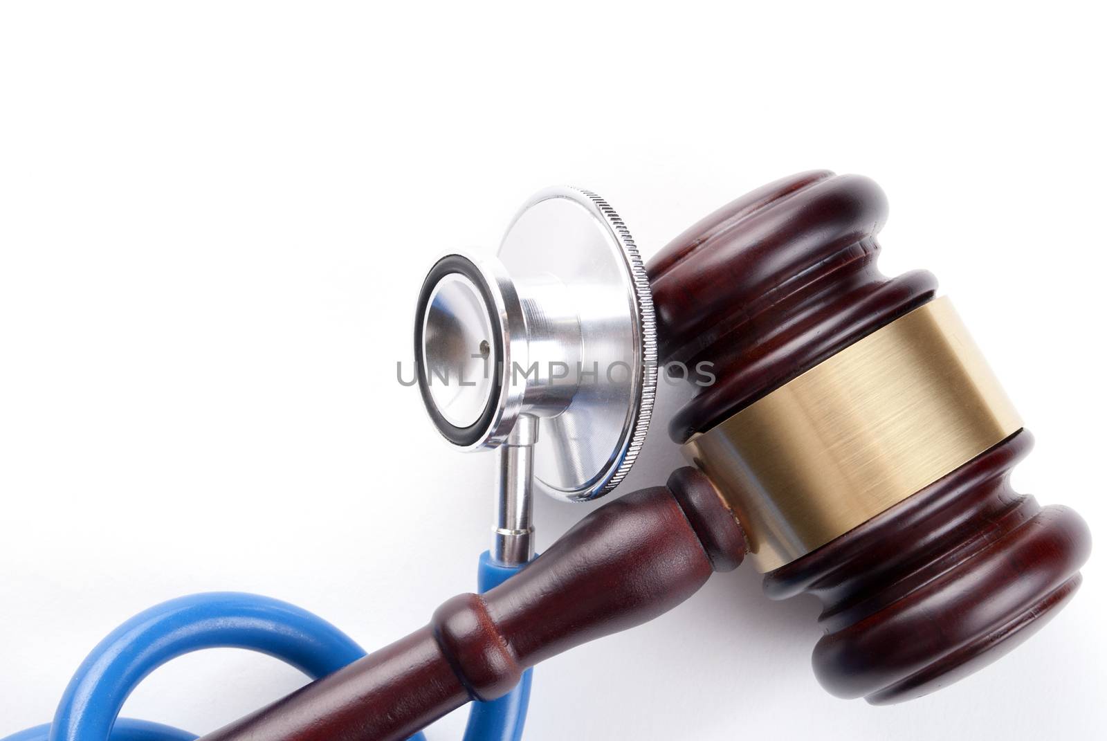 brown gavel and a medical stethoscope on white background