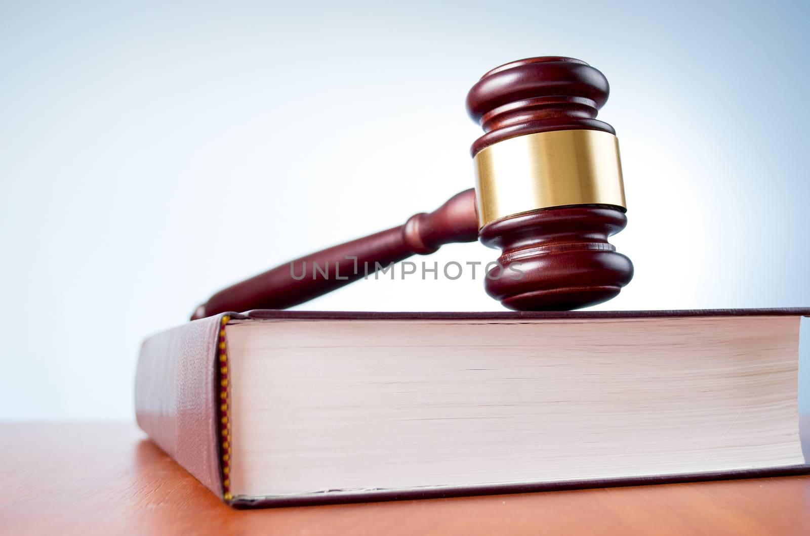 judges gavel and law book on a blue background