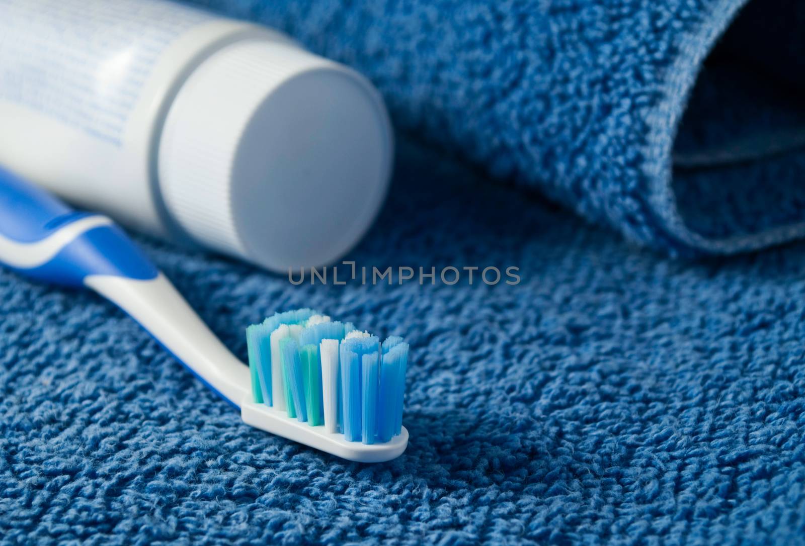 Toothbrush and toothpaste lie on a towel..