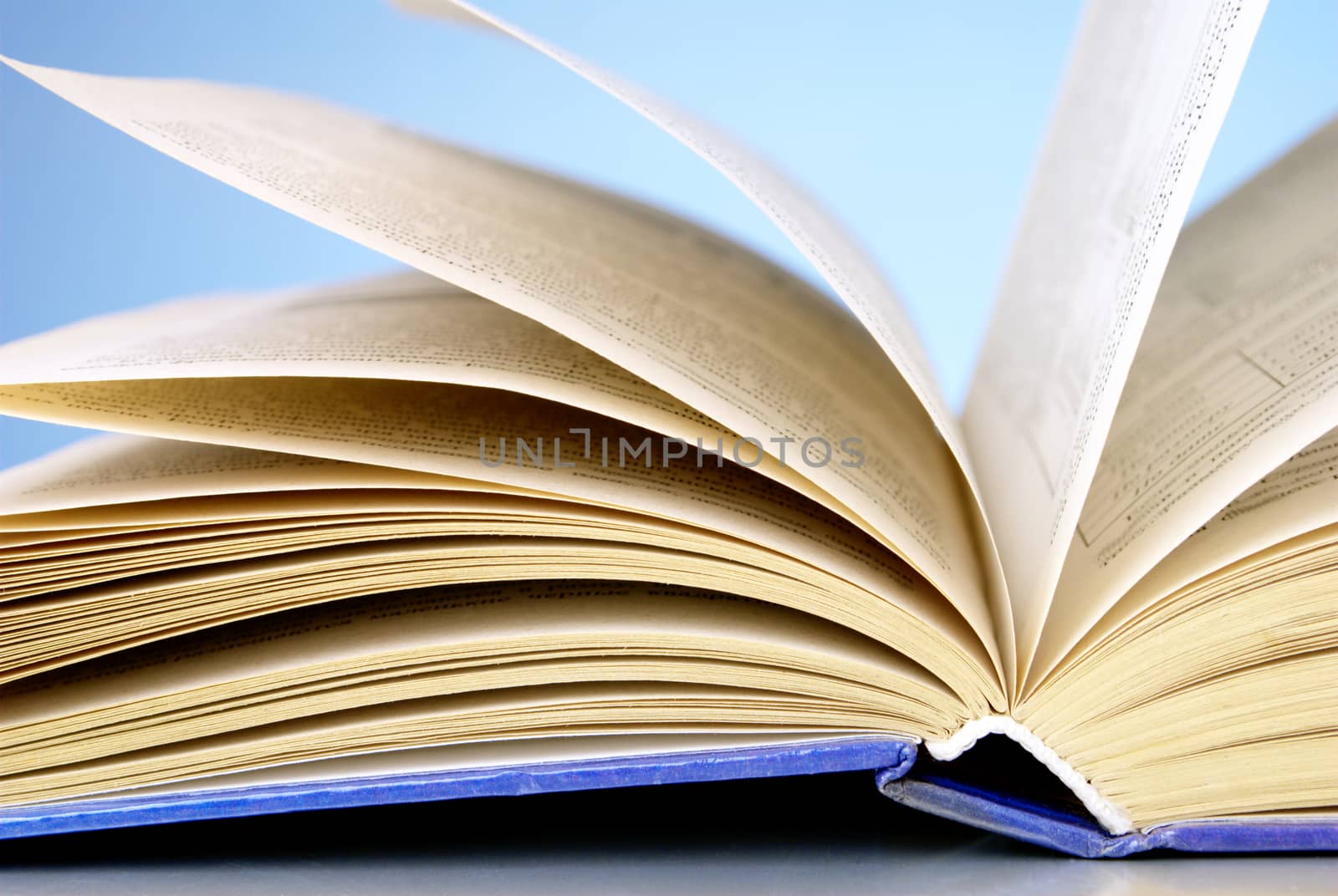 An open book on a blue gradient background