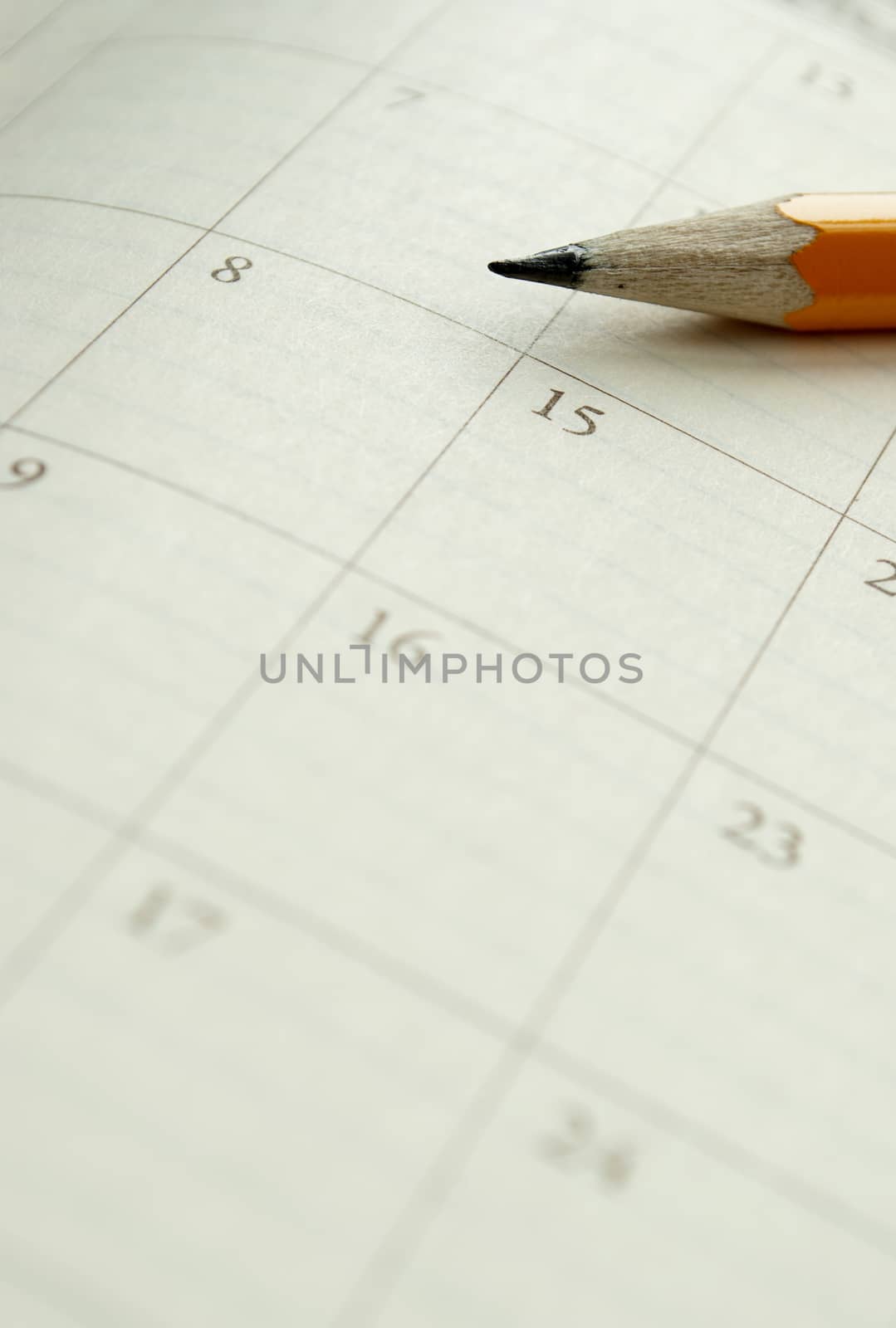 home calendar with dates and yellow sharpened pencil