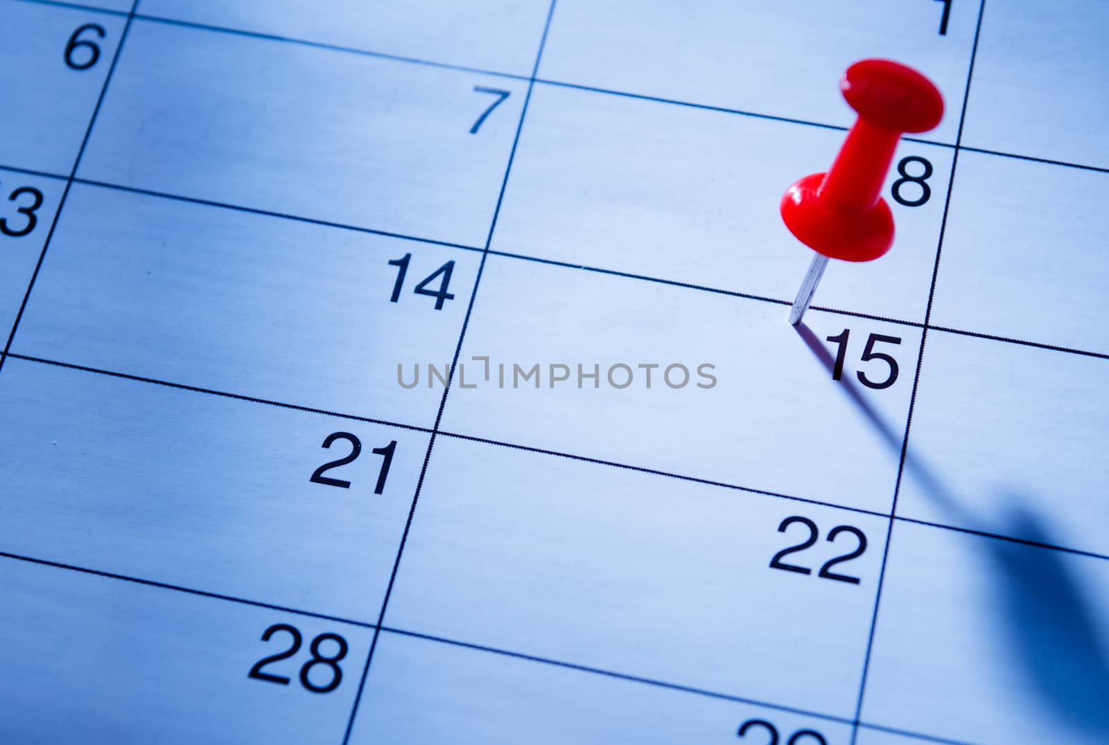 Red pin marking the 15th on a calendar by sergii_gnatiuk