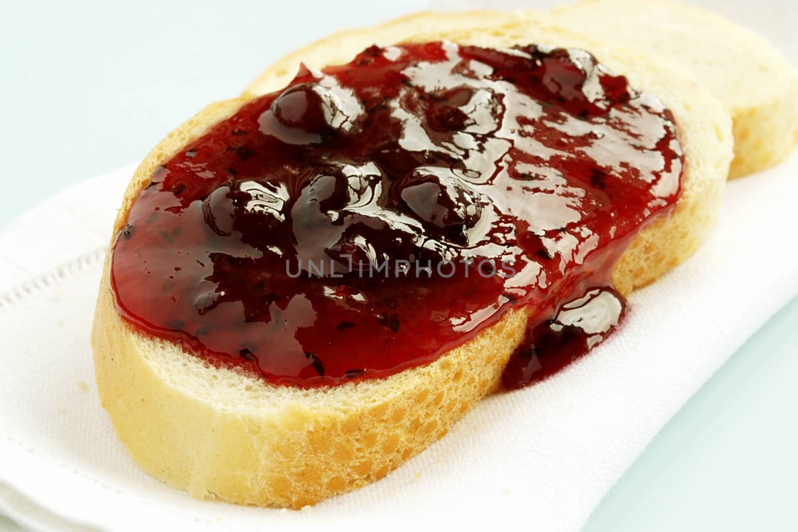 bread and jam from the berries on a white napkin