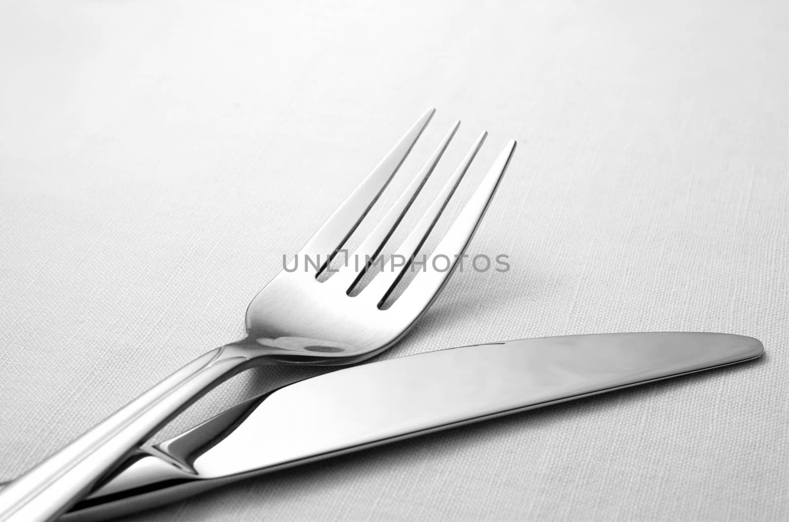fork and knife on a napkin on the table by sergii_gnatiuk