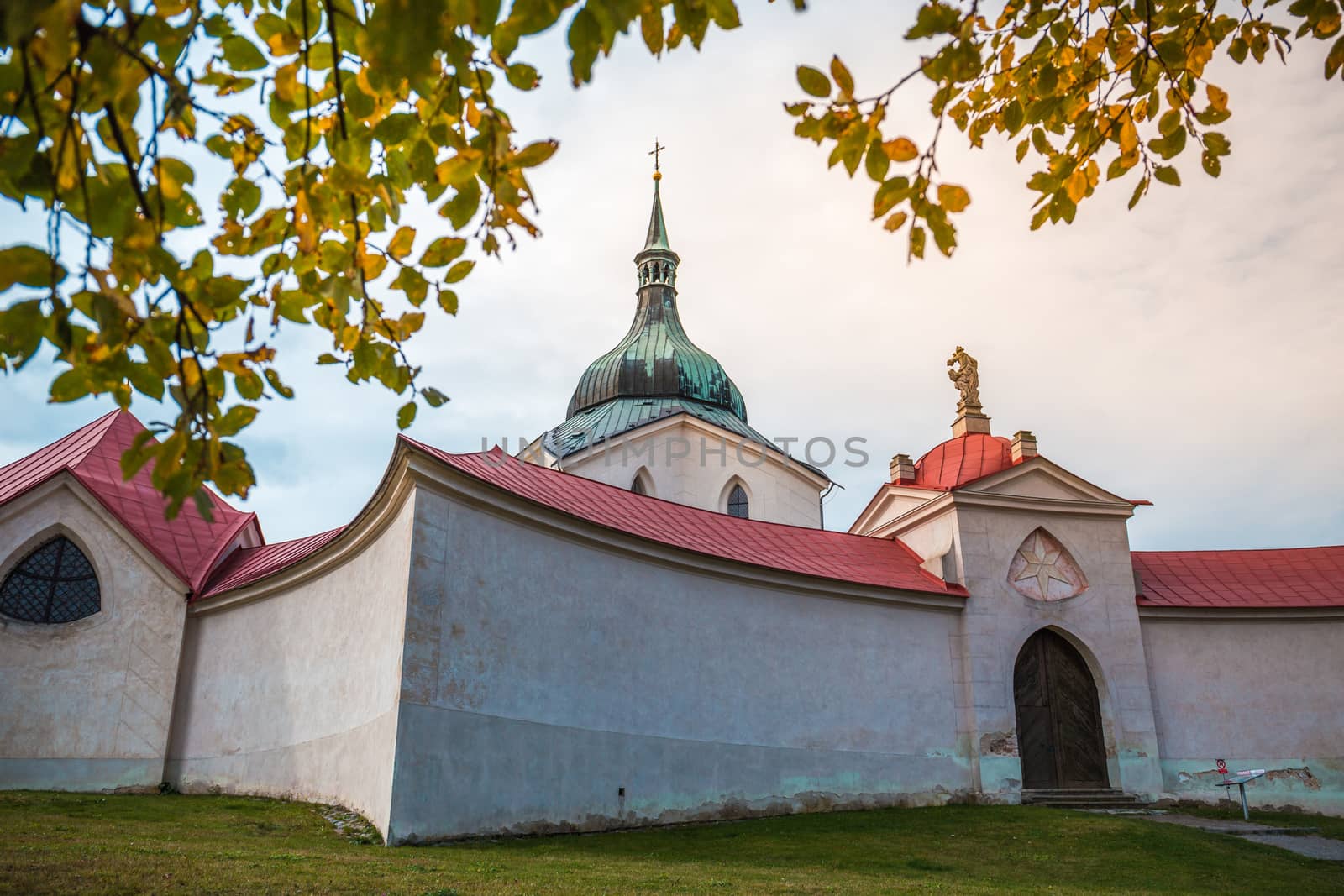 Pilgrimage Church of St John of Nepomuk at Zelena hora in Zdar nad Sazavou, national cultural heritage and the UNESCO World heritage monument - close up shot with autumn leaves in the foreground. by petrsvoboda91