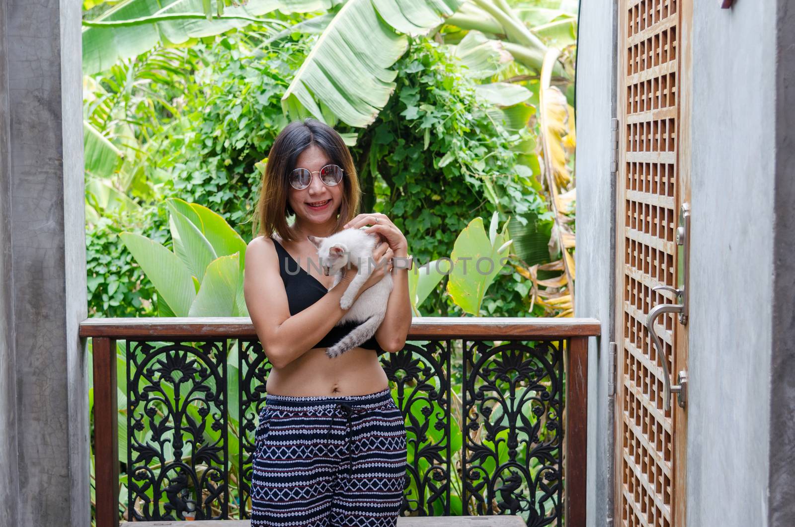 Beautiful Asian woman is playing with a cat