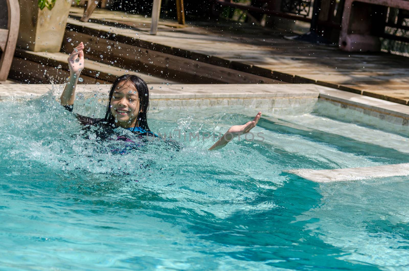 Asian girl in swimming pool.